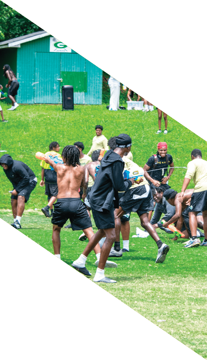 A football team is gathered around a coach, listening to his instructions. AI generated content