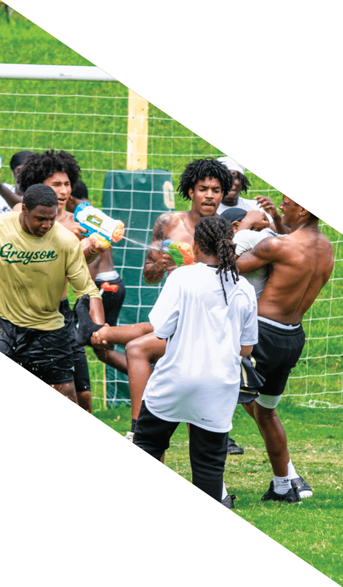 A group of people wearing black jerseys are huddled together on a field. AI generated content