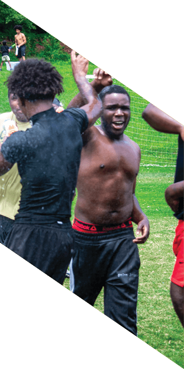 A group of football players wearing headphones and smiling. AI generated content