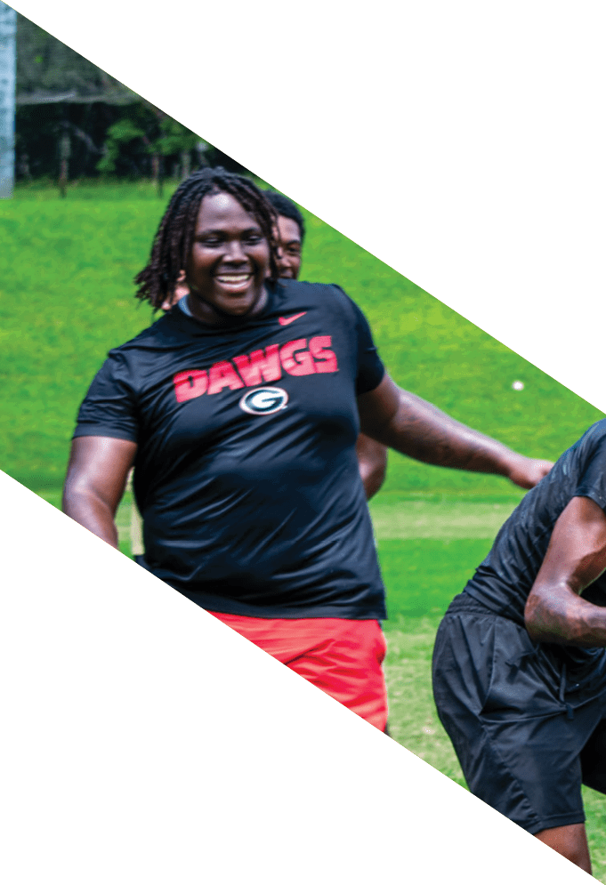 Four football players pose for a picture on the field. AI generated content