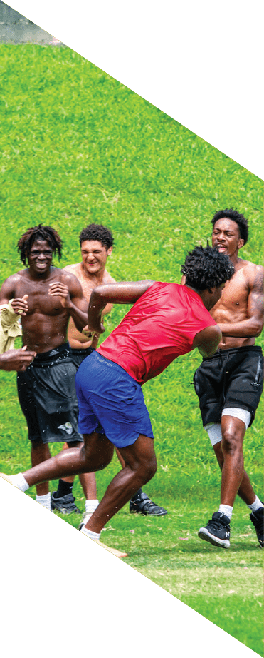 A football player wearing a helmet and white uniform is holding his helmet above his head. AI generated content