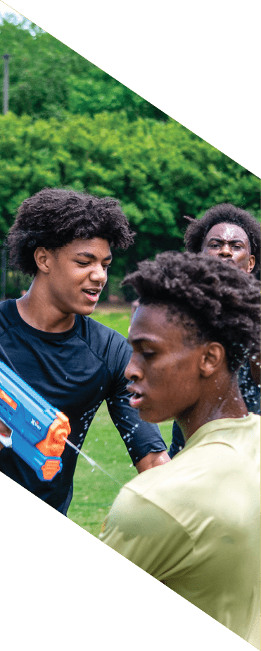 A football player wearing a white jersey with the number 86 catches a football in the air. AI generated content