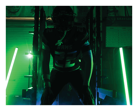 A man wearing a football uniform is jumping to catch a football. AI generated content