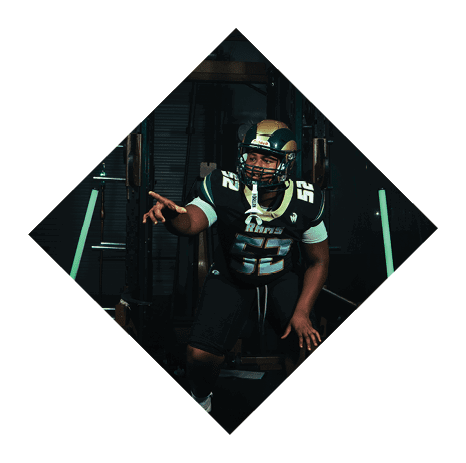 A football player wearing a black jersey with the number 3 kneels on the field. AI generated content