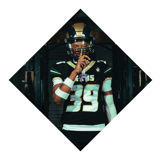 A football player wearing a black jersey with the number 16 on it is holding a football. AI generated content