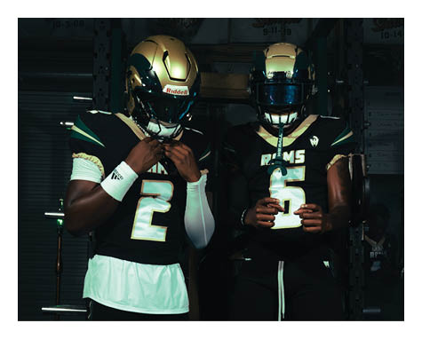 Two football players celebrating a touchdown with one player jumping in the air. AI generated content