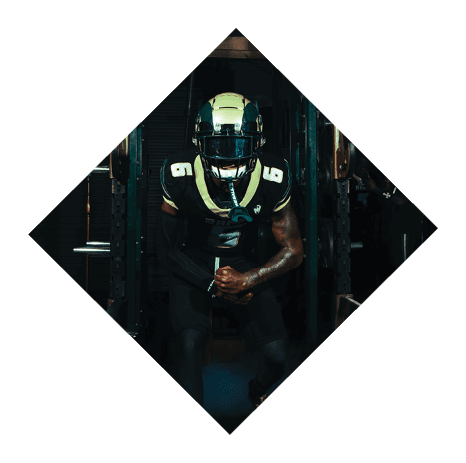 A football player wearing a black jersey with the number 3 kneels on the field. AI generated content