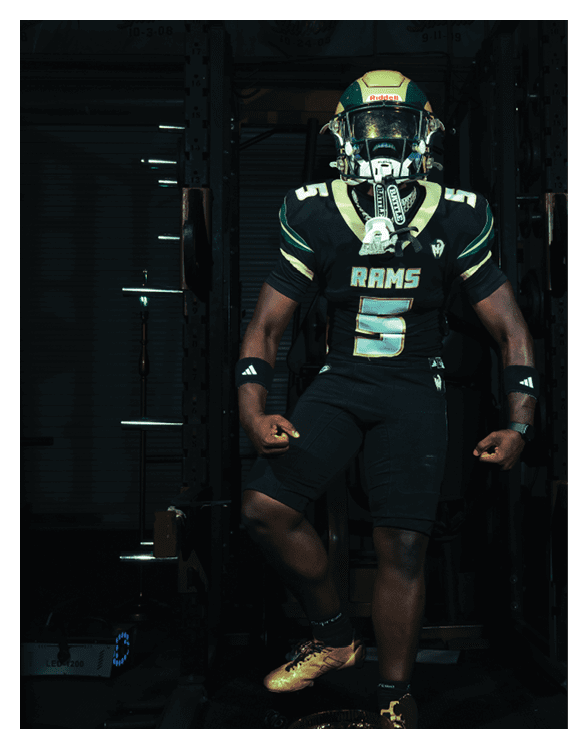 A football player wearing a helmet and white uniform is holding his helmet above his head. AI generated content