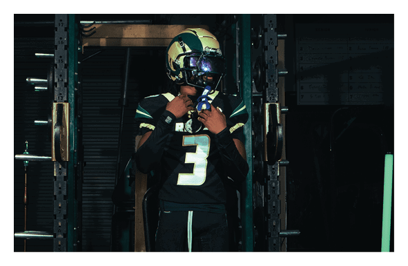 A group of football players wearing headphones and smiling. AI generated content
