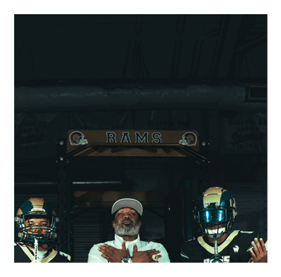 Two men wearing football helmets are talking to each other. AI generated content