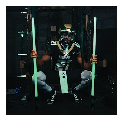 A football player in a white jersey with the number 85 on it is trying to catch a football. AI generated content