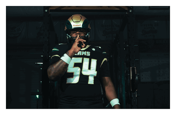 A group of football players wearing headphones and smiling. AI generated content