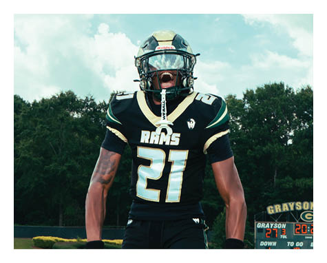 Two football players celebrating a touchdown with one player jumping in the air. AI generated content