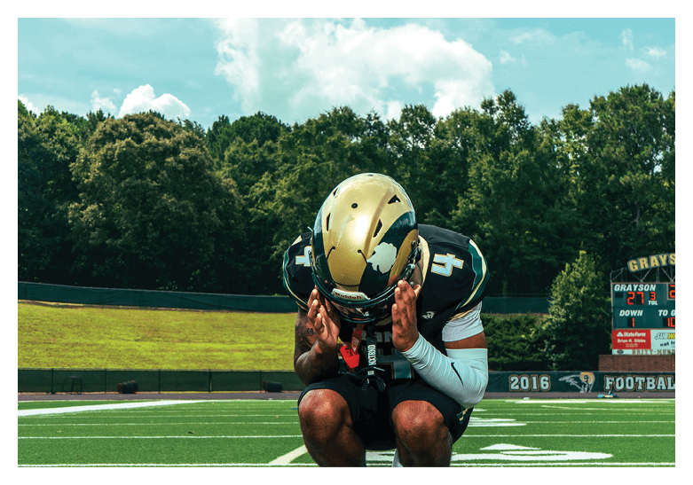 A group of football players on a field, one of them is running with a football. AI generated content