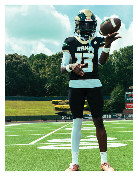 A football player wearing a helmet and white uniform is holding his helmet above his head. AI generated content