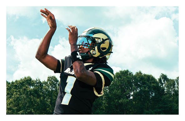 A group of people are kneeling on a field, possibly in a football game. AI generated content