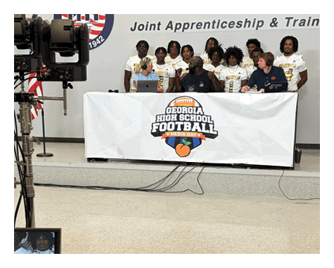A man wearing a football uniform is jumping to catch a football. AI generated content