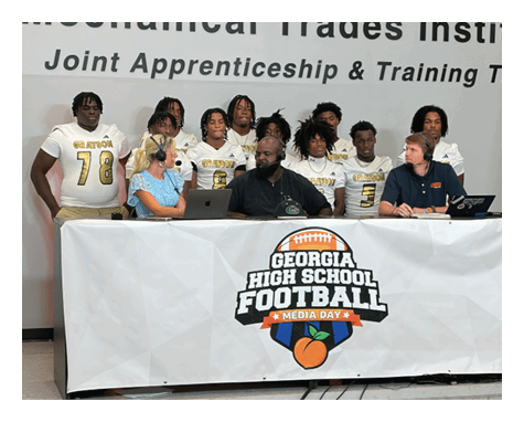 Two football players celebrating a touchdown with one player jumping in the air. AI generated content