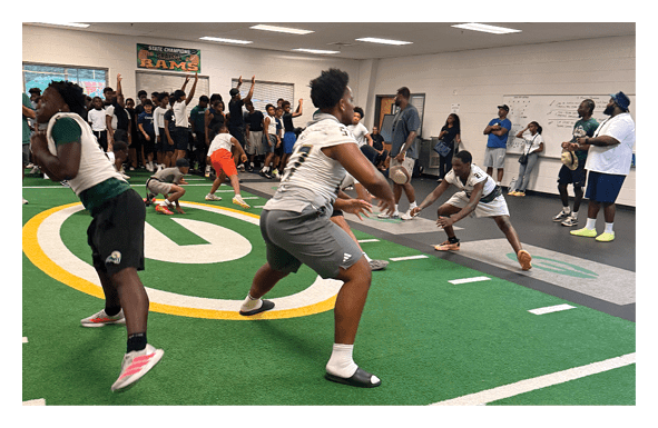 A group of football players wearing headphones and smiling. AI generated content
