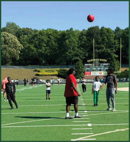 A football player catching a ball. Description generated by AI