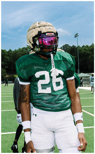 A football player catching a ball. Description generated by AI