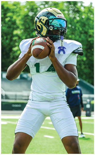 A football player catching a ball. Description generated by AI