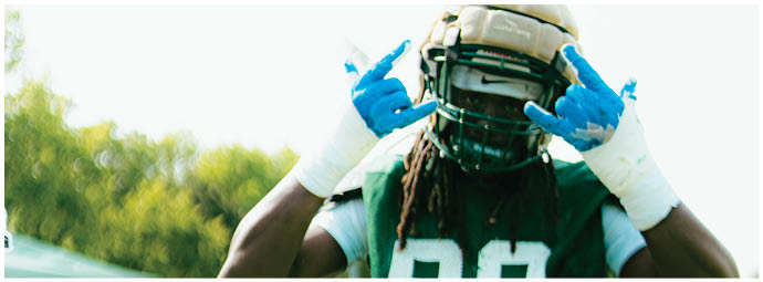 A football player wearing a blue and white uniform. Description generated by AI