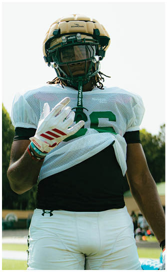 A football player catching a ball. Description generated by AI