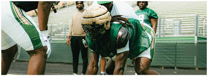 A football player wearing a blue and white uniform. Description generated by AI