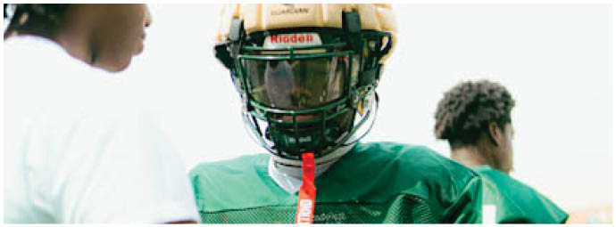 A football player wearing a blue and white uniform. Description generated by AI