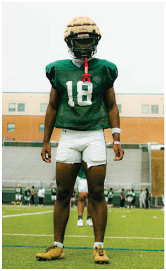 A football player catching a ball. Description generated by AI