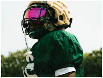 A group of football players on a field. Description generated by AI
