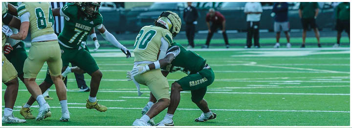 A football player is sliding on the ground. Description generated by AI