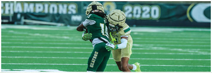 A group of football players on a field. Description generated by AI