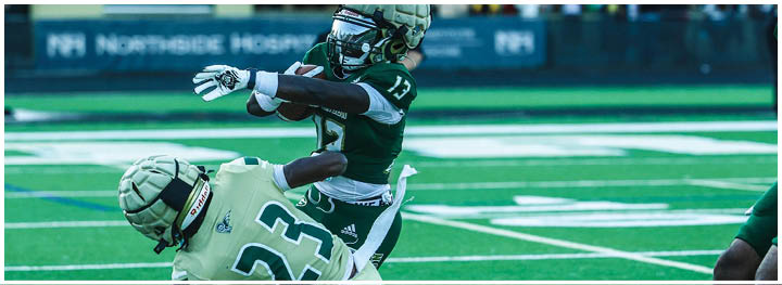 A football player is sliding on the ground. Description generated by AI
