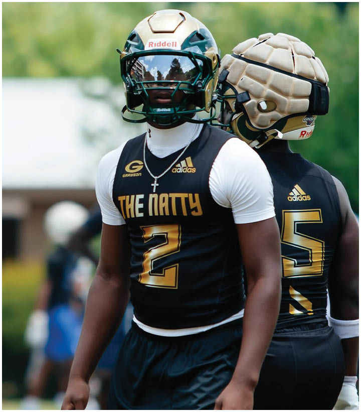 A group of football players wearing black and white uniforms. Description generated by AI