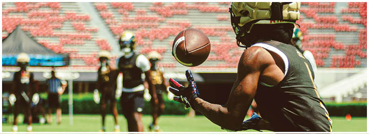 A football player is sliding on the ground. Description generated by AI