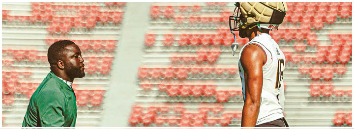 A football player is sliding on the ground. Description generated by AI