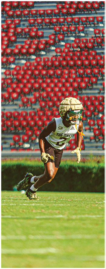 A football player running on the field. Description generated by AI