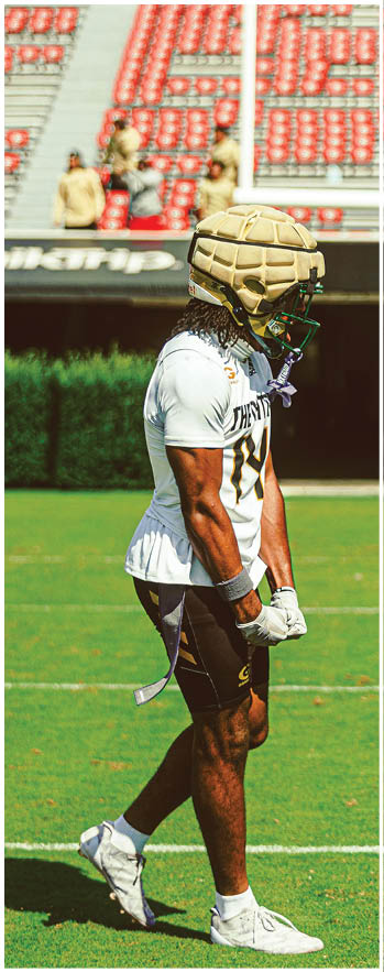 A football player running on the field. Description generated by AI