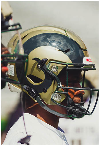 A football player running on the field. Description generated by AI