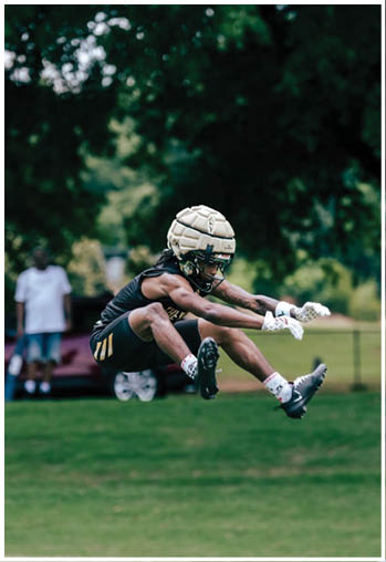 A football player running on the field. Description generated by AI