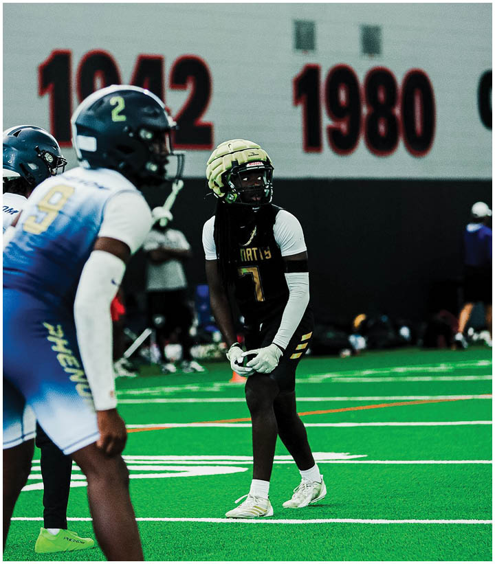 A group of football players wearing black and white uniforms. Description generated by AI