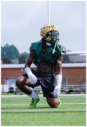 A football player running on the field. Description generated by AI