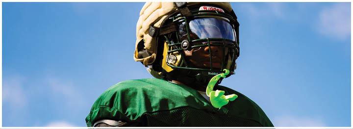 A football player is sliding on the ground. Description generated by AI