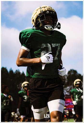 A football player running on the field. Description generated by AI