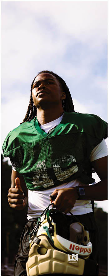 A football player running on the field. Description generated by AI