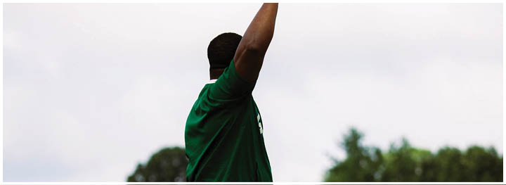 A football player is sliding on the ground. Description generated by AI