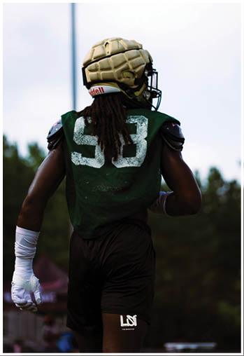 A football player running on the field. Description generated by AI