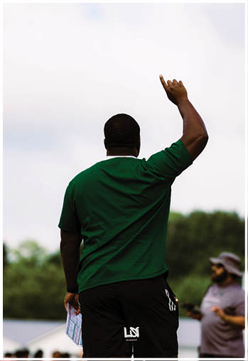 A football player running on the field. Description generated by AI